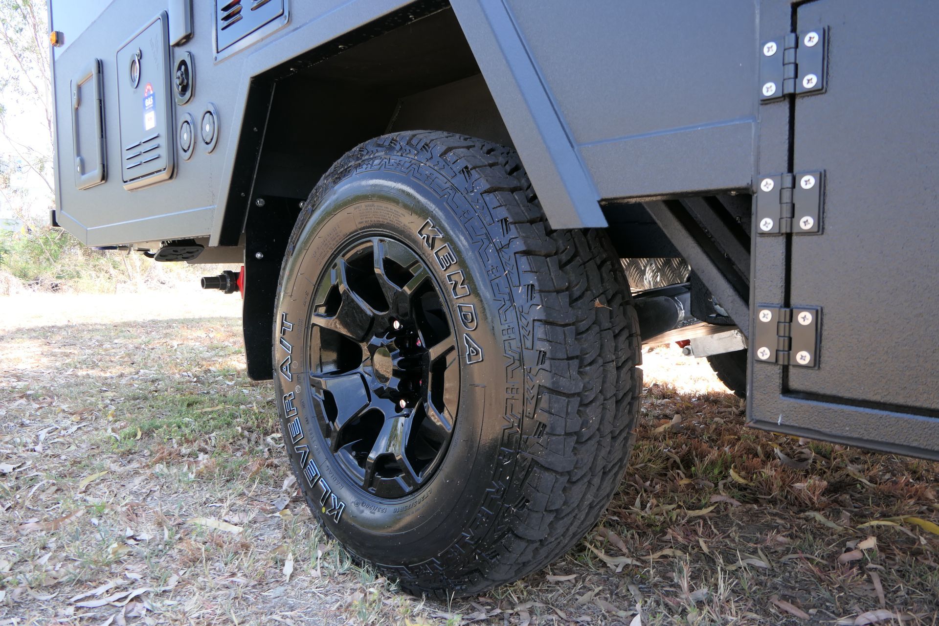 A close up of a tire on a black vehicle.