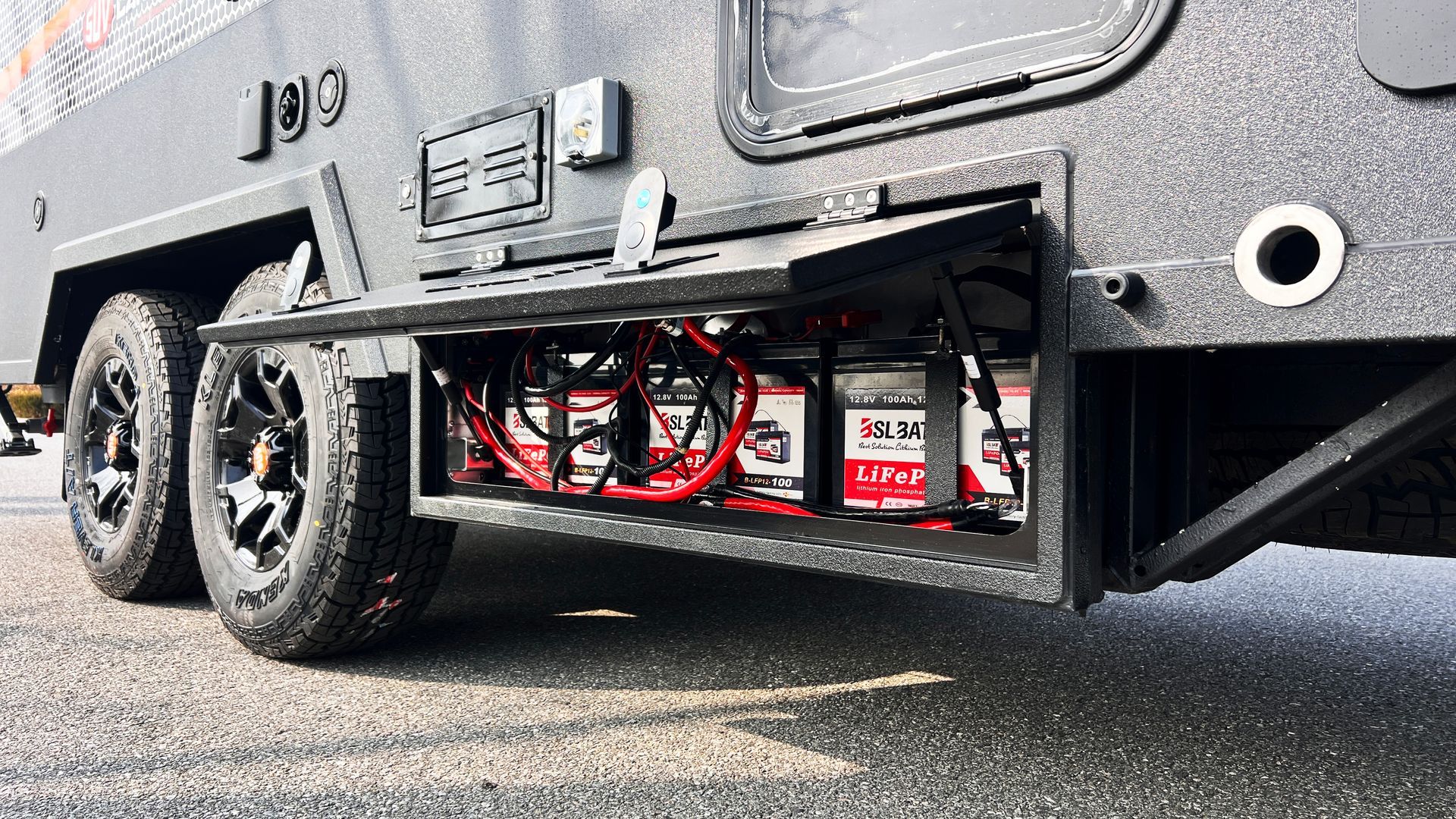 A close up of a trailer with a bunch of batteries in it.