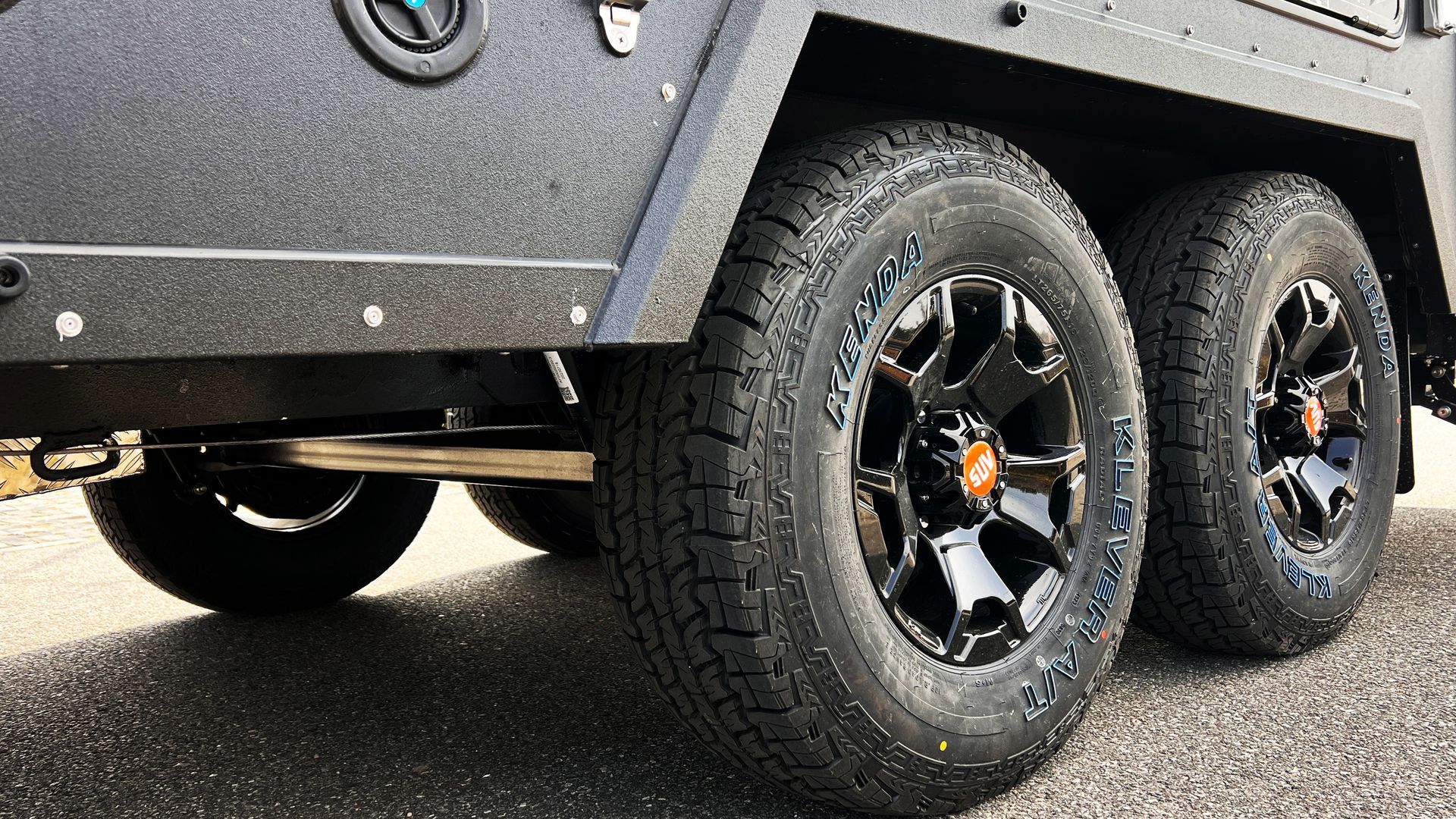 A close up of a trailer with two tires on it.