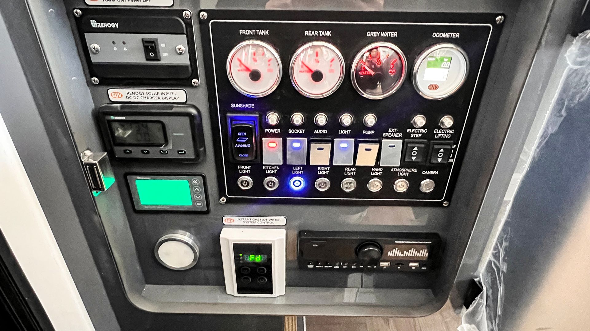 A dashboard with a lot of buttons and gauges on it.
