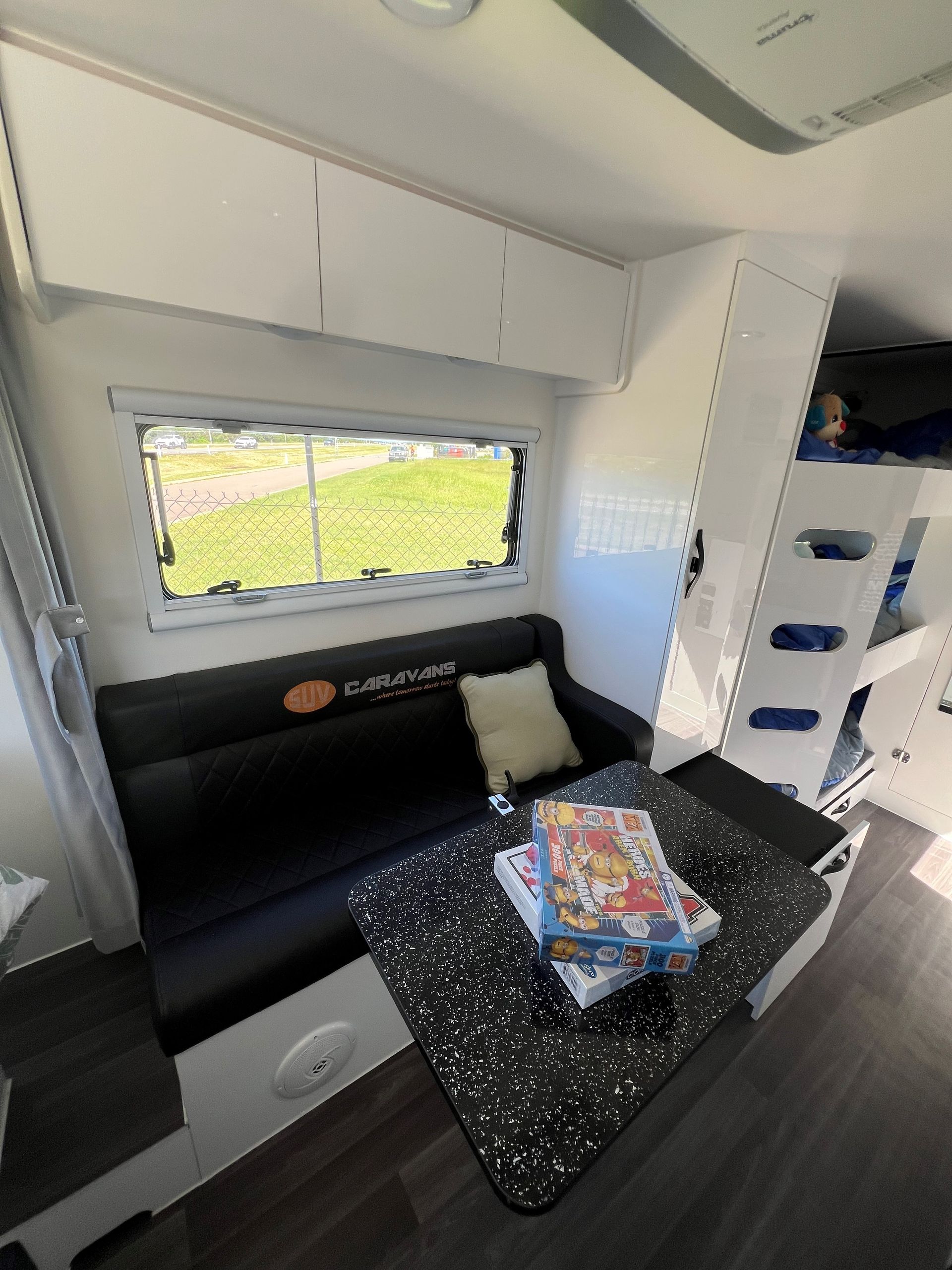 A living room in a camper with a couch and a table.