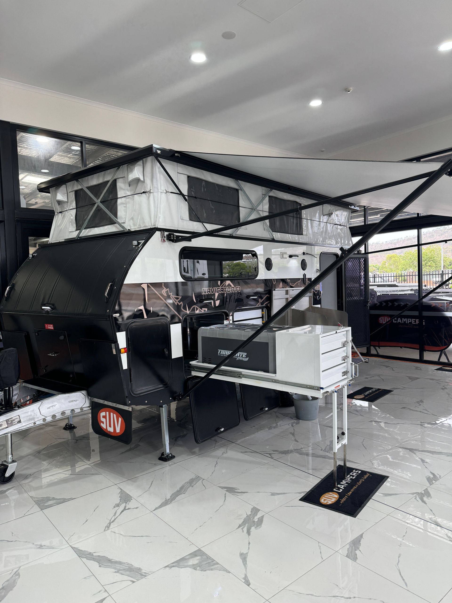 A camper is sitting on top of a table in a room.