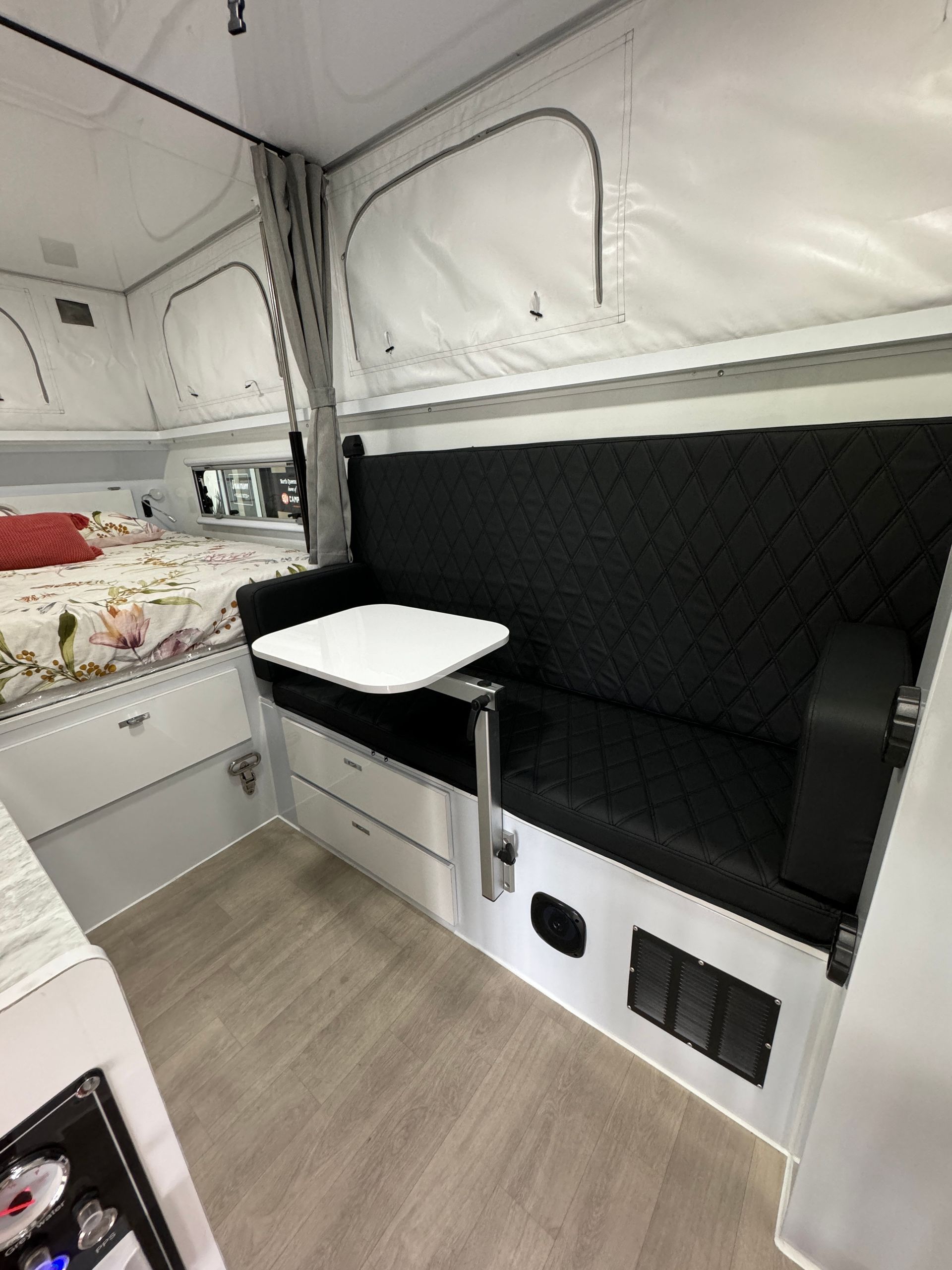 A camper with a couch and a table in it.