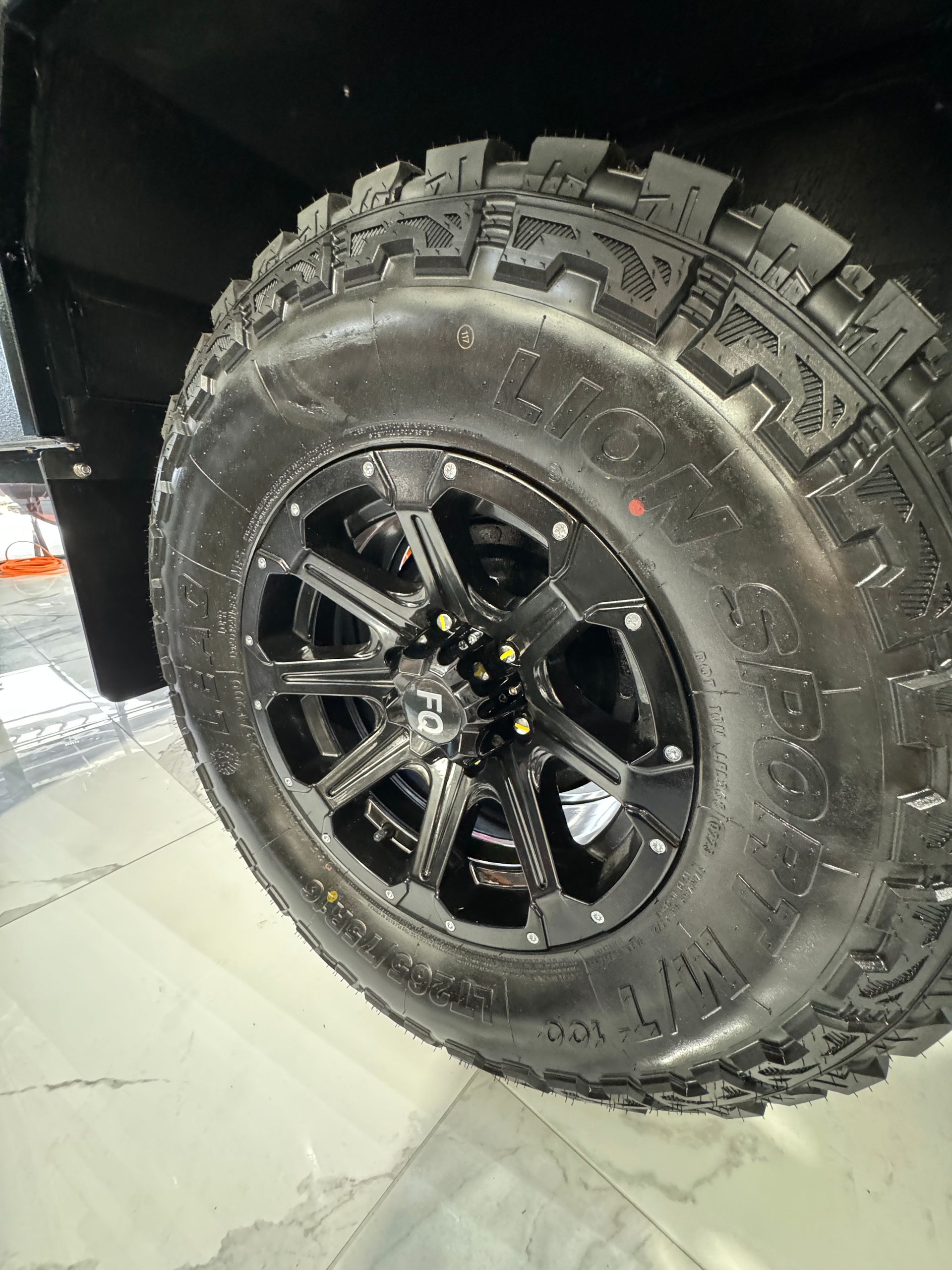 A close up of a tire and wheel on a truck.