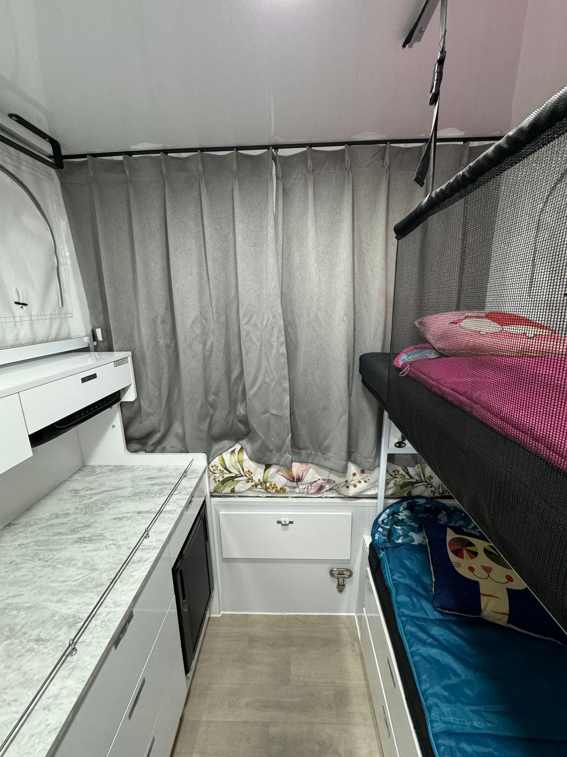 A bedroom with two bunk beds and a dresser.