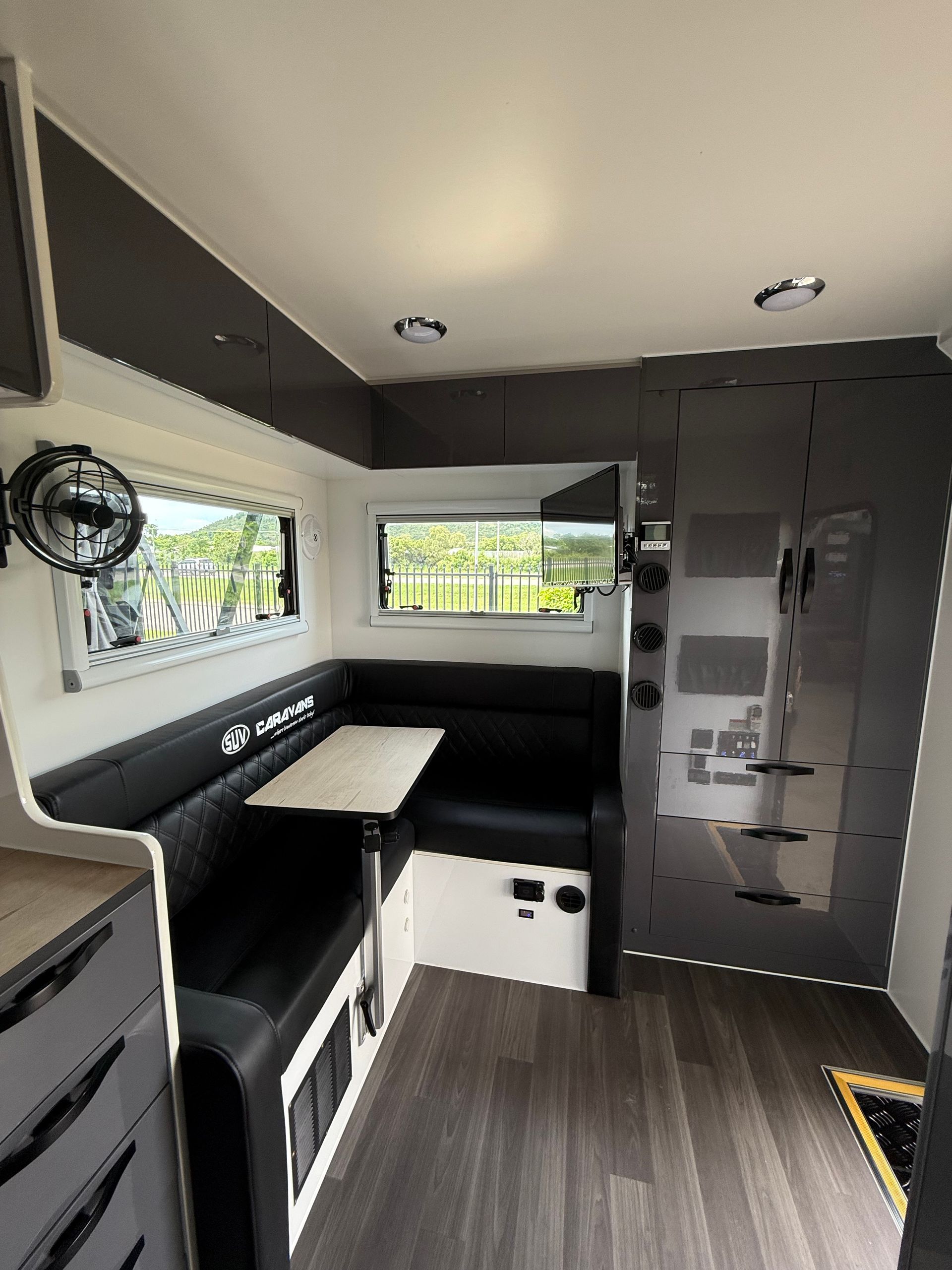 The inside of a camper with a table and couch.