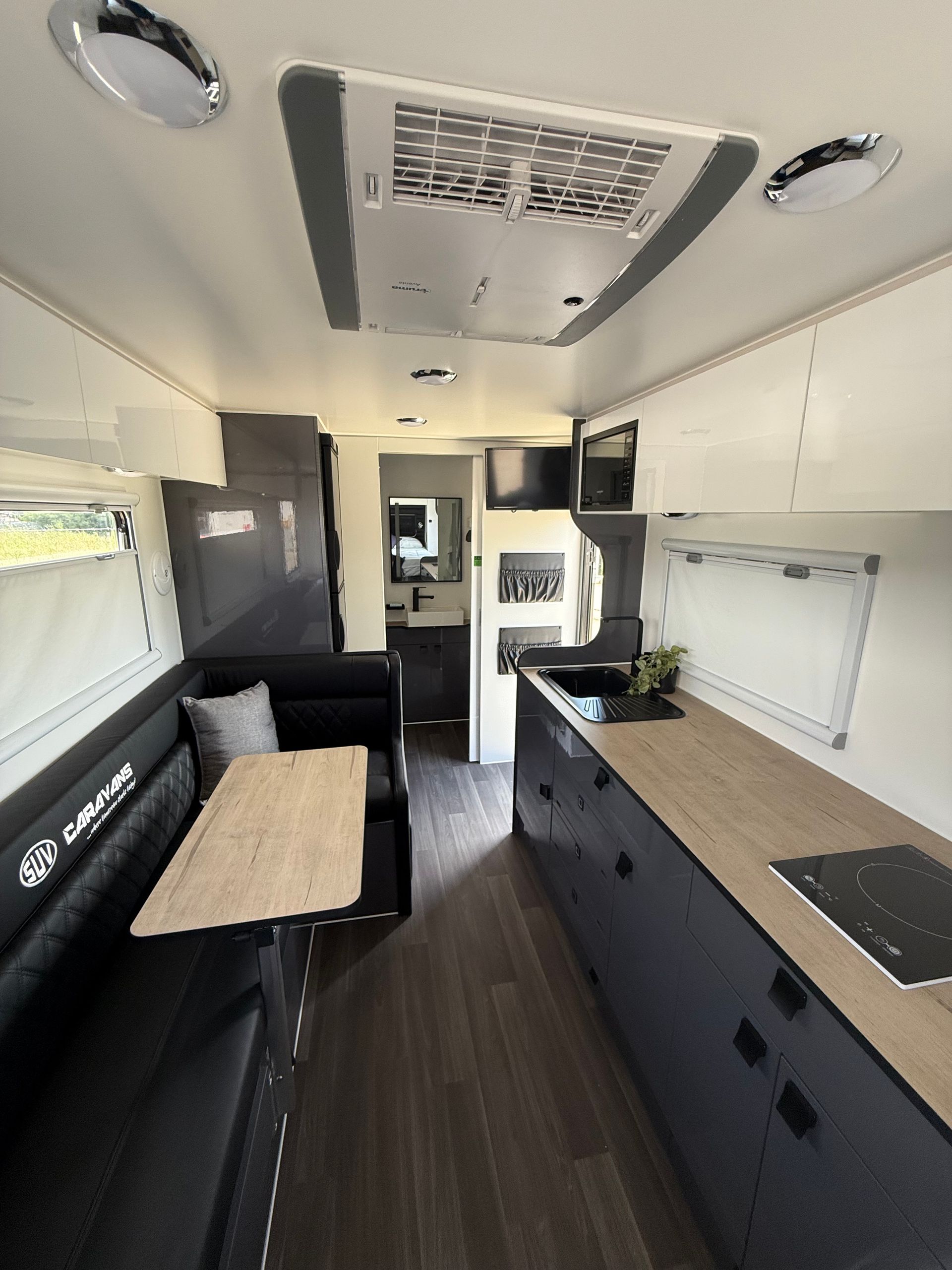 The inside of a camper van with a table and couch.