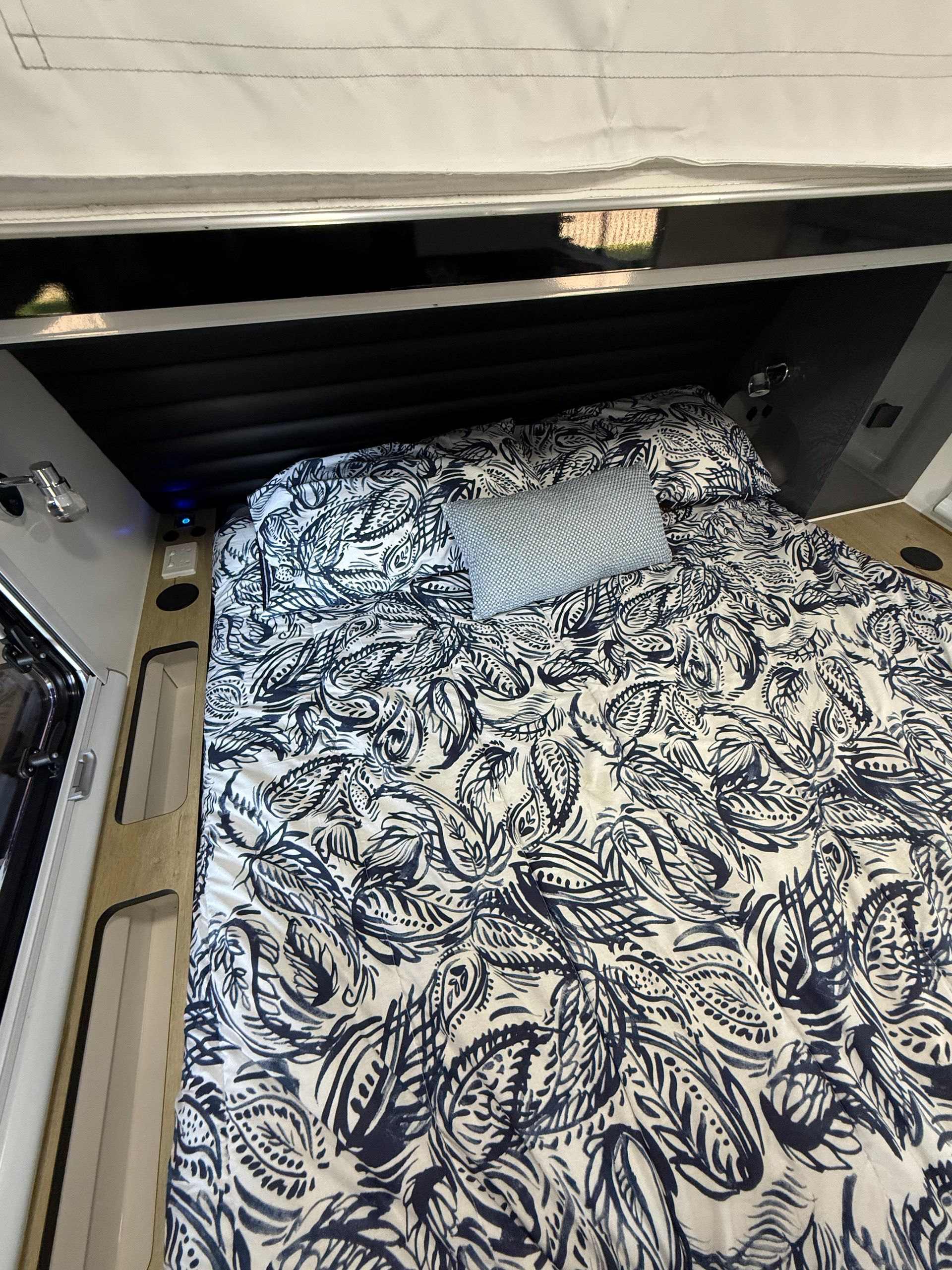 A bed with a blue and white pattern on it