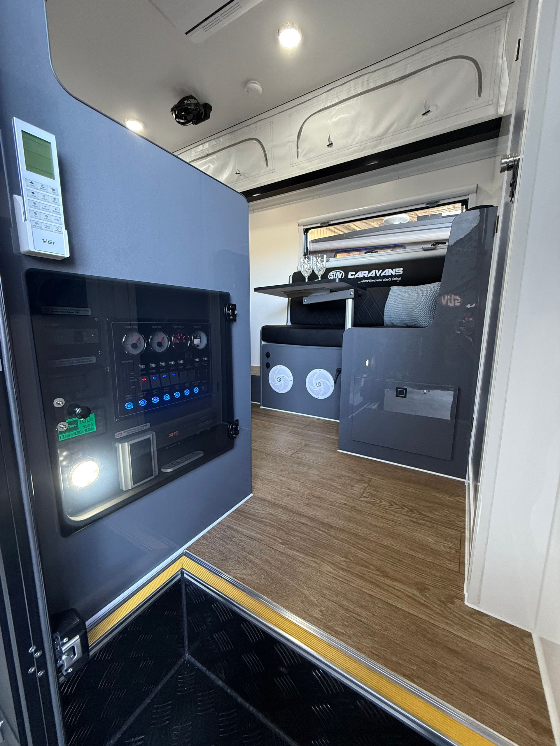 The inside of a camper van with a table and chairs.