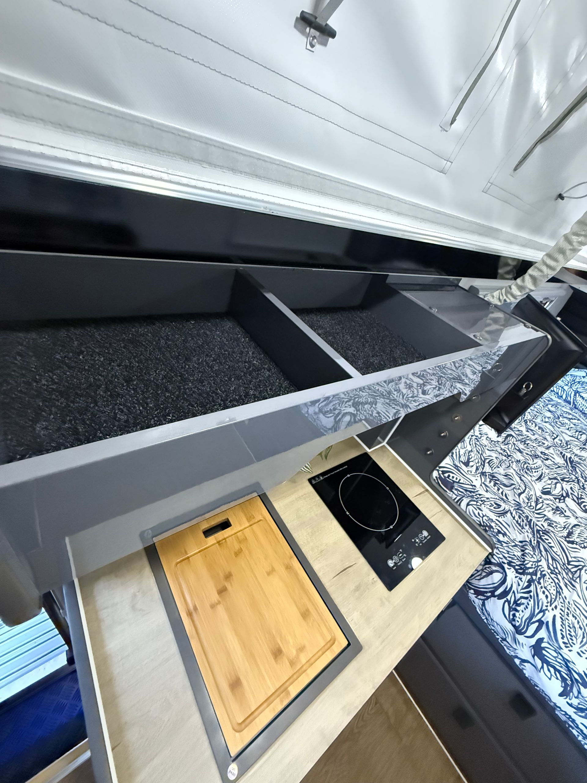 A kitchen with a cutting board and a stove top oven