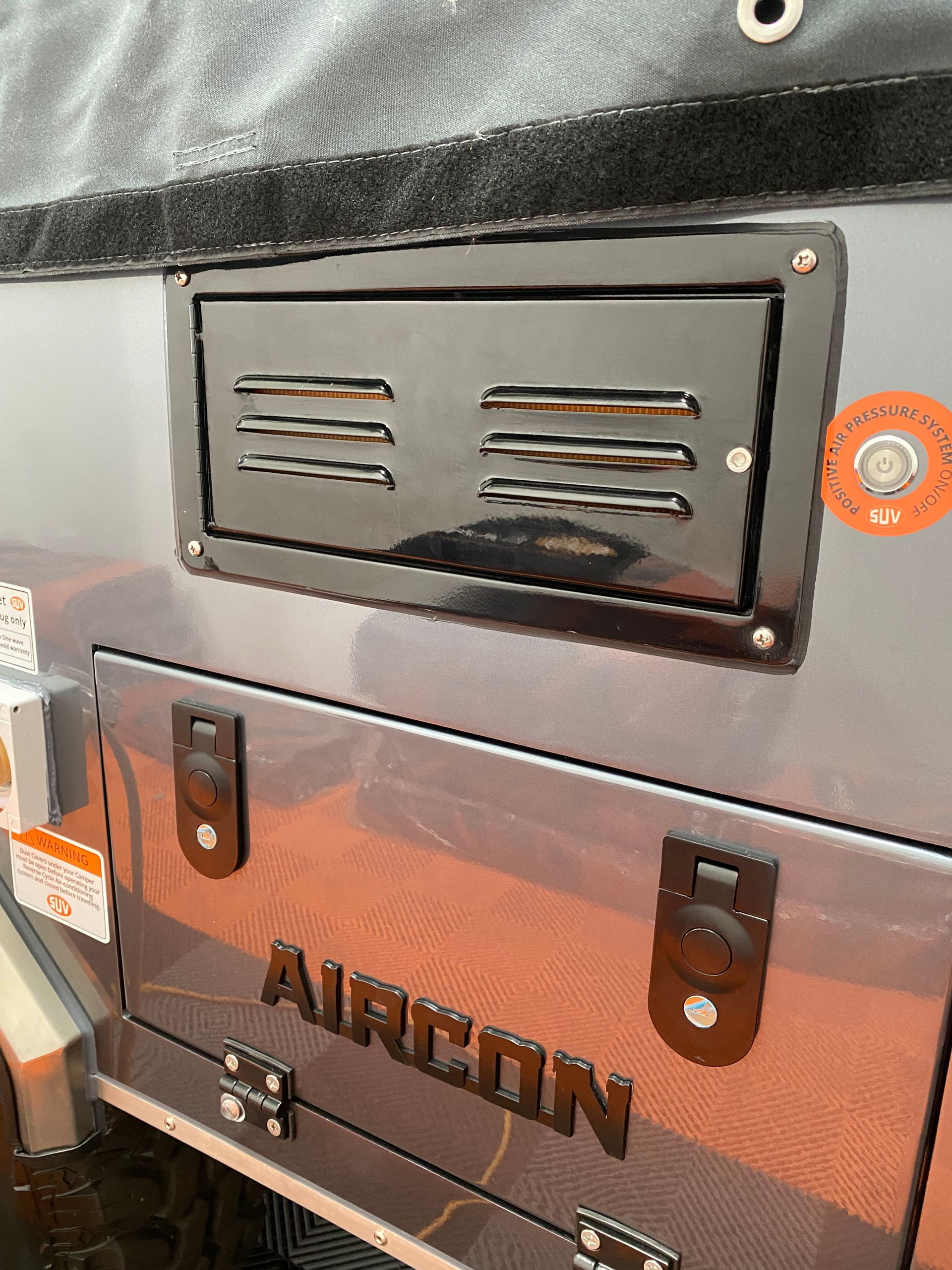 A close up of a metal box with the word aircon on it.