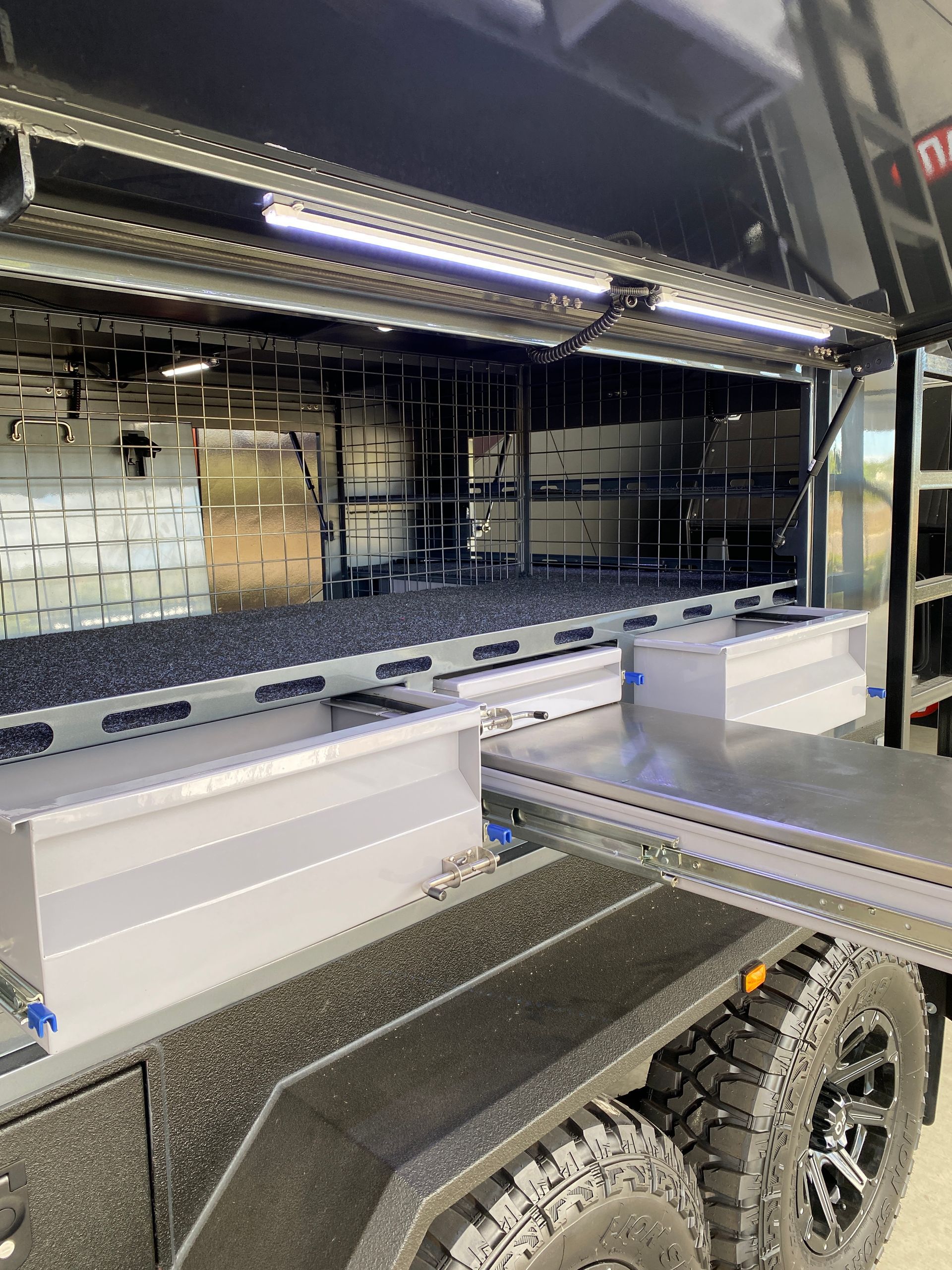 The inside of a trailer with a lot of storage space.