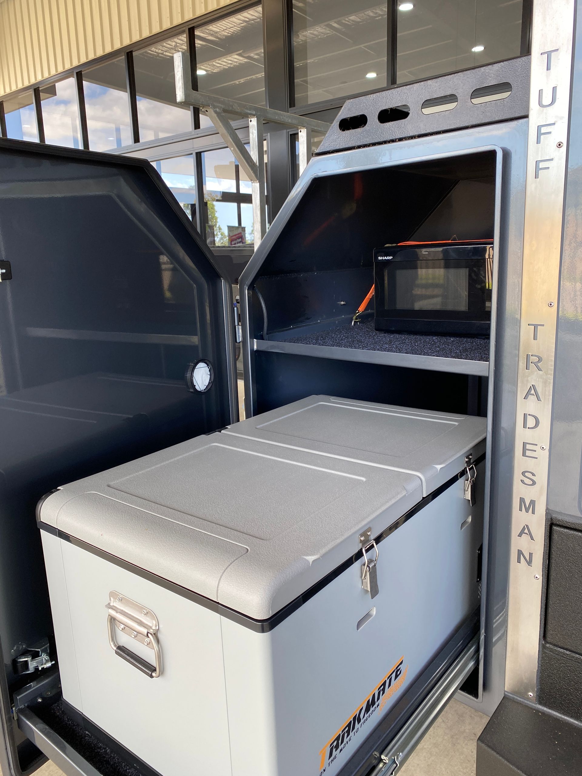A cooler is sitting in the back of a truck.
