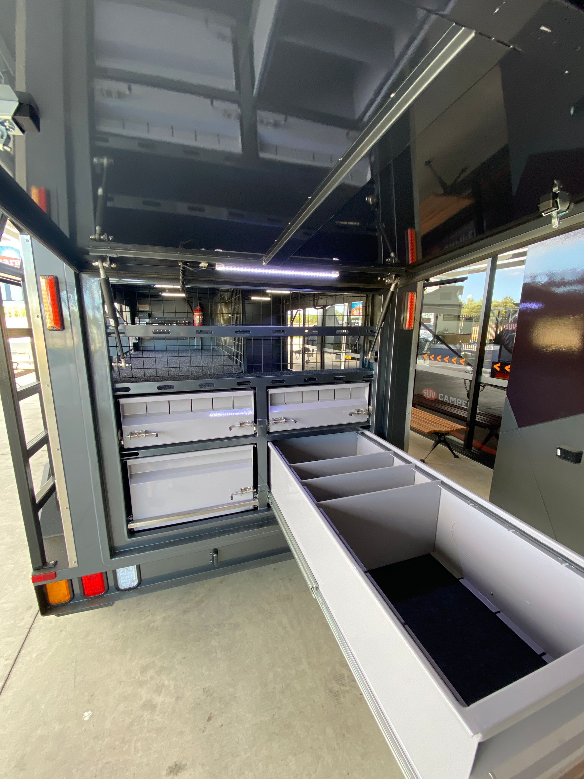 The inside of a trailer with drawers and shelves.