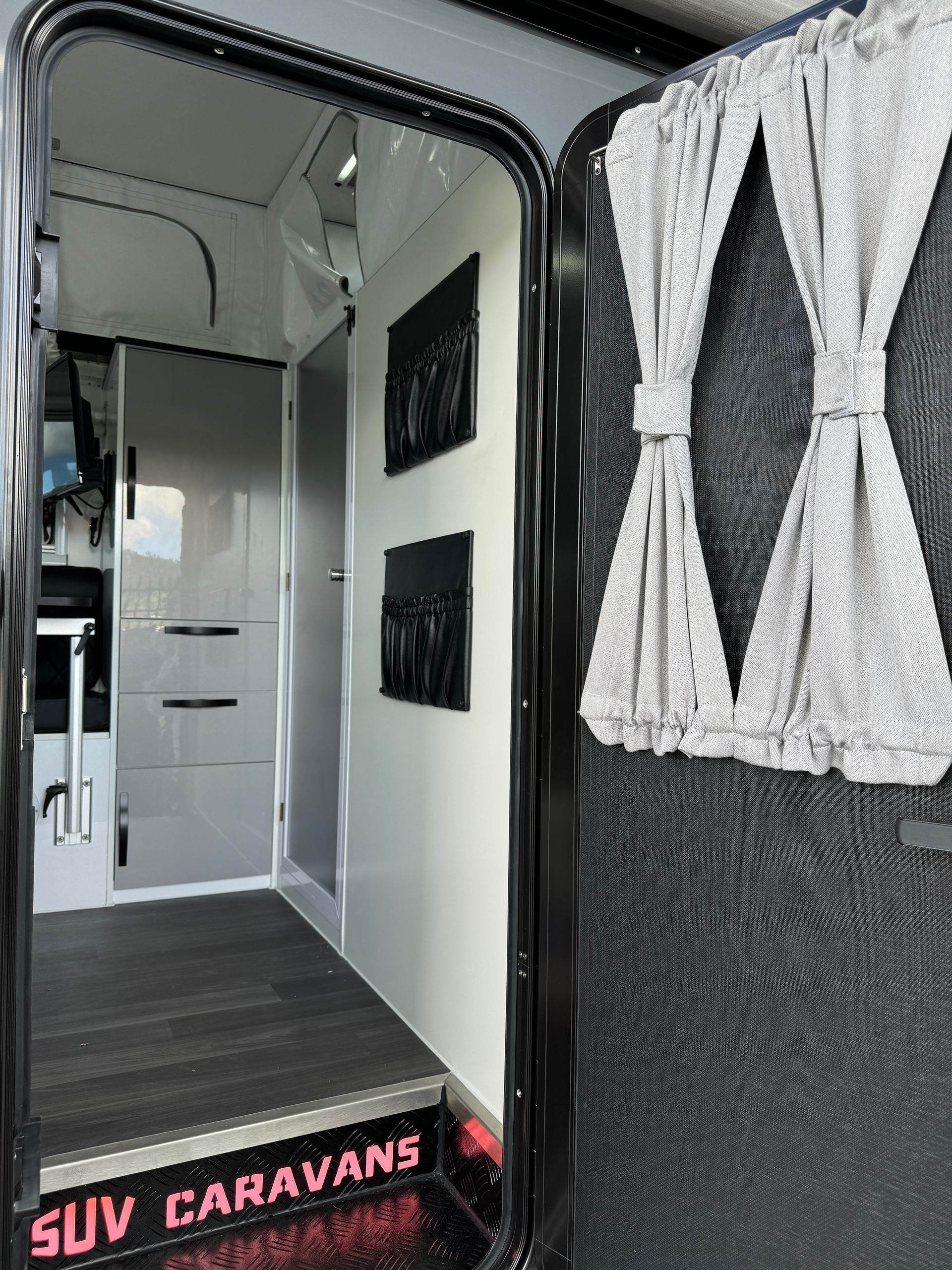 The inside of a suv caravan with the door open