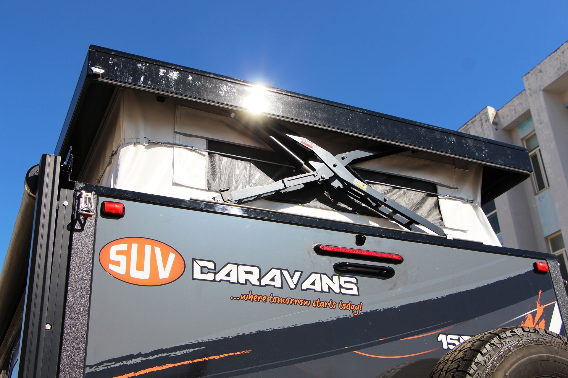 The back of a suv pop top van