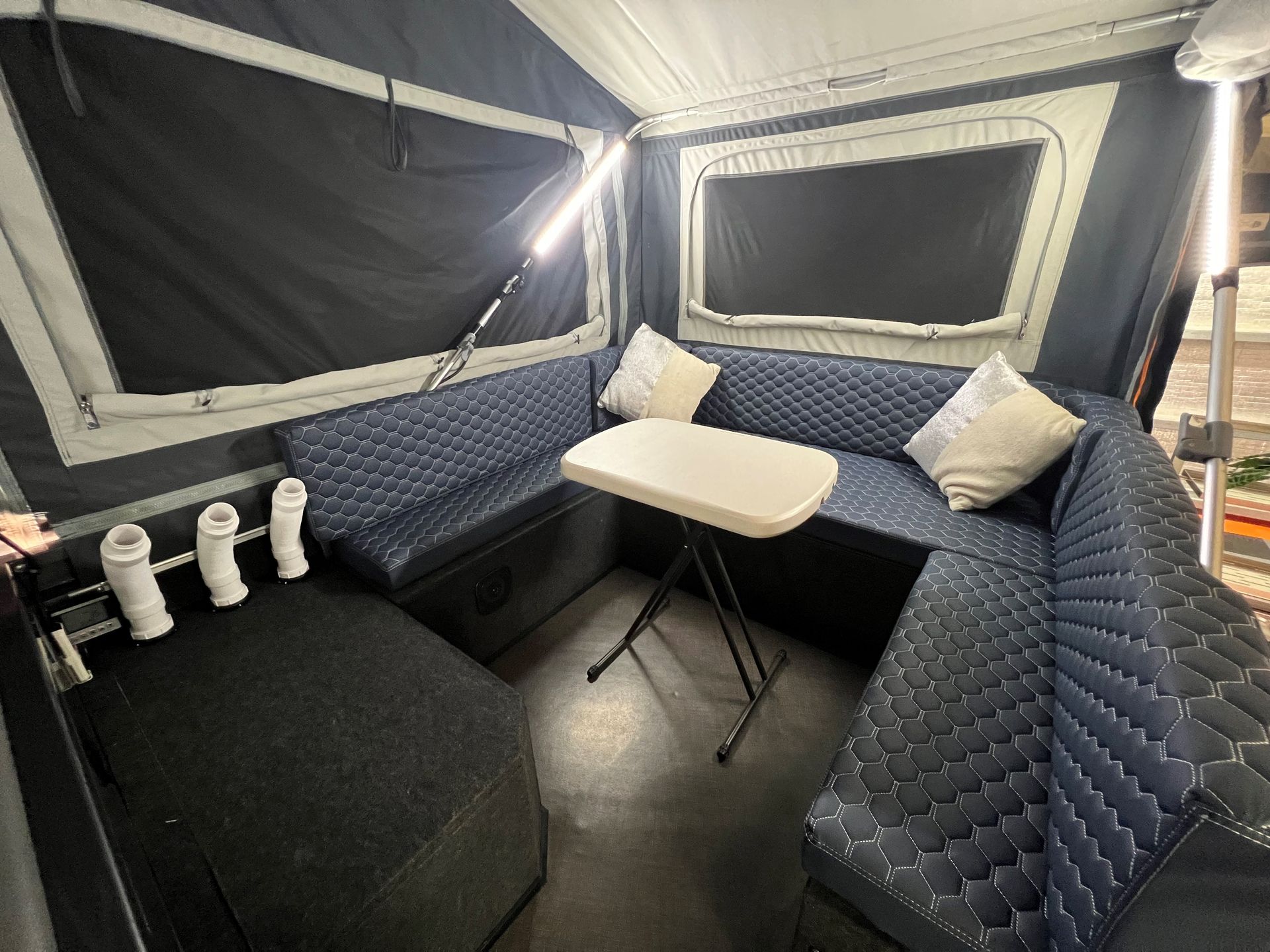 A living room in a camper with a couch and a table.
