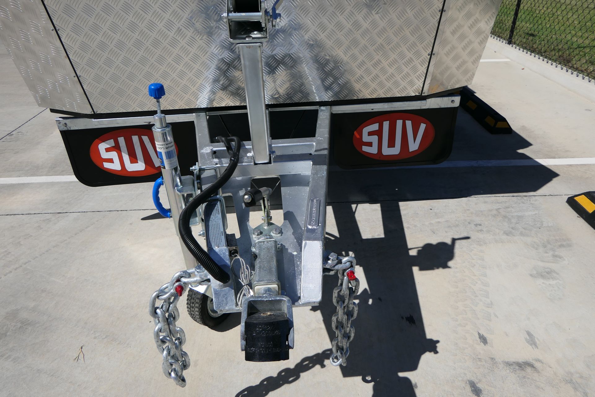 A suv trailer is parked on the side of the road