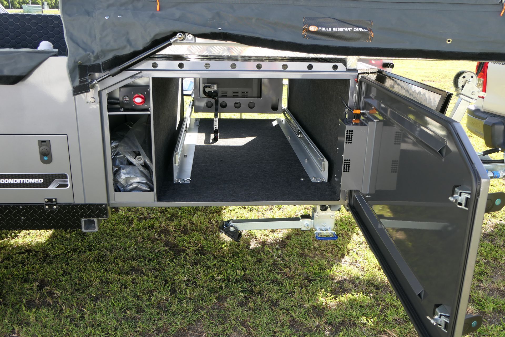 The back of a trailer with the door open and a lot of storage space.
