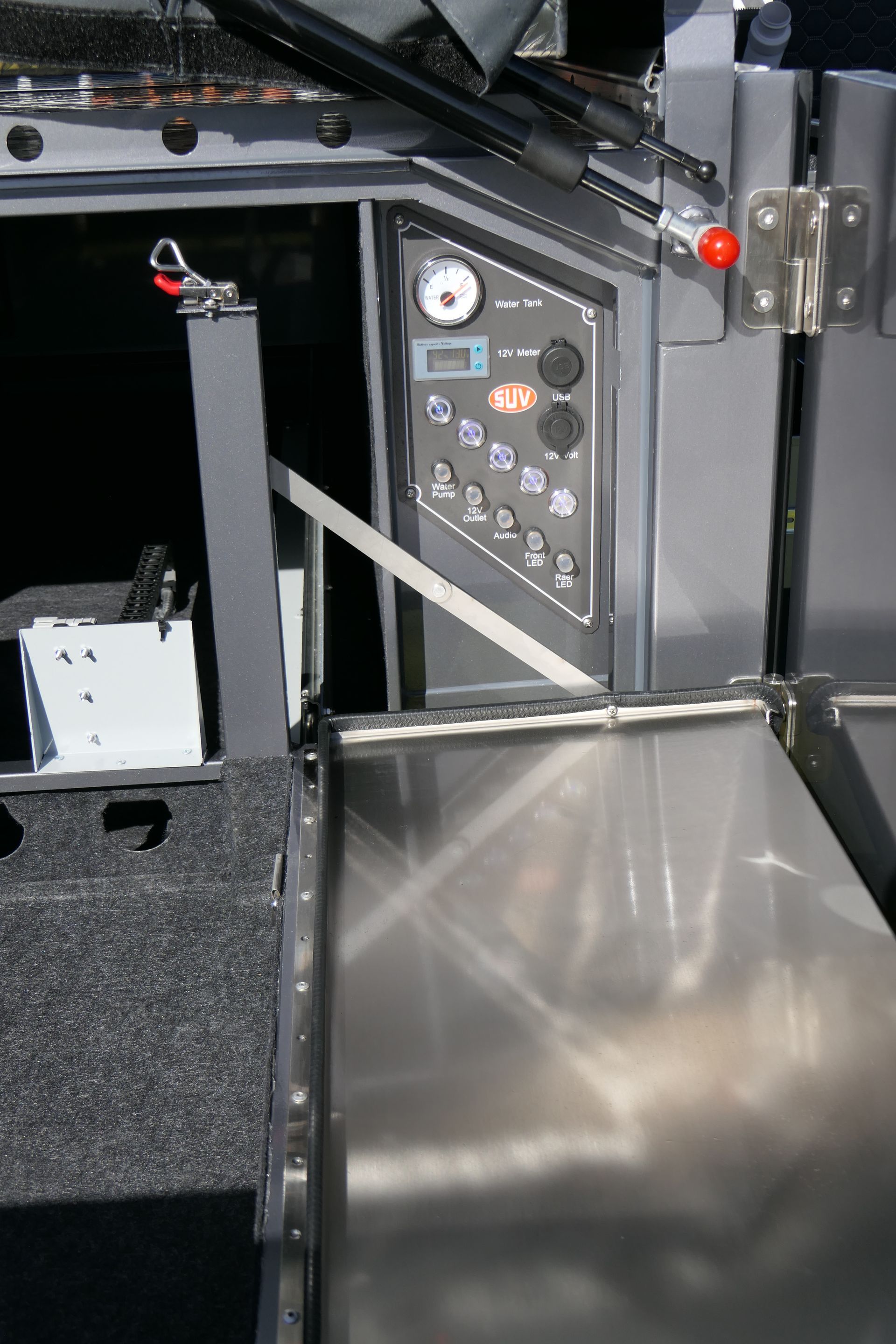 A close up of a stainless steel tray on a boat.