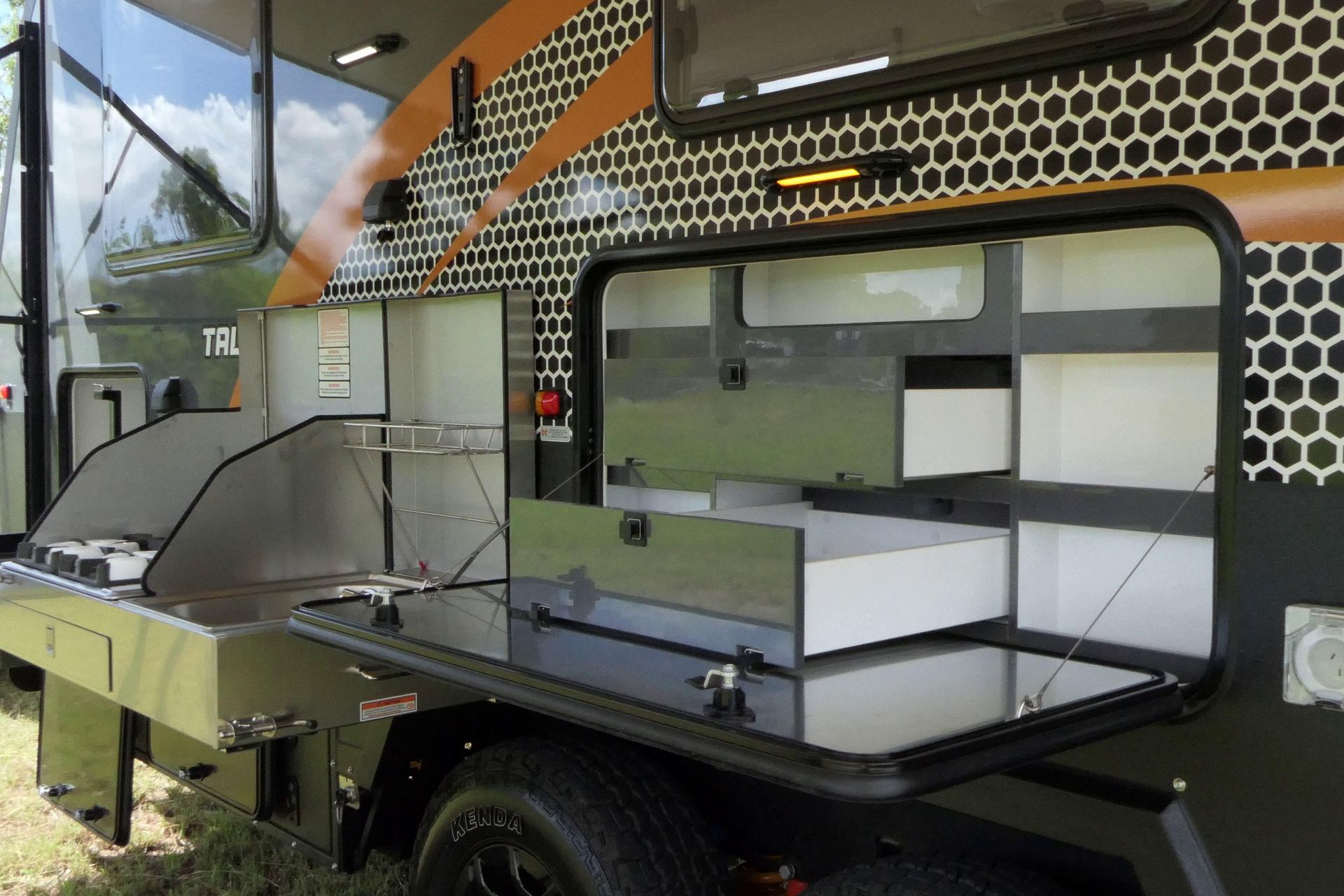 A trailer with a kitchen and a stove on it.