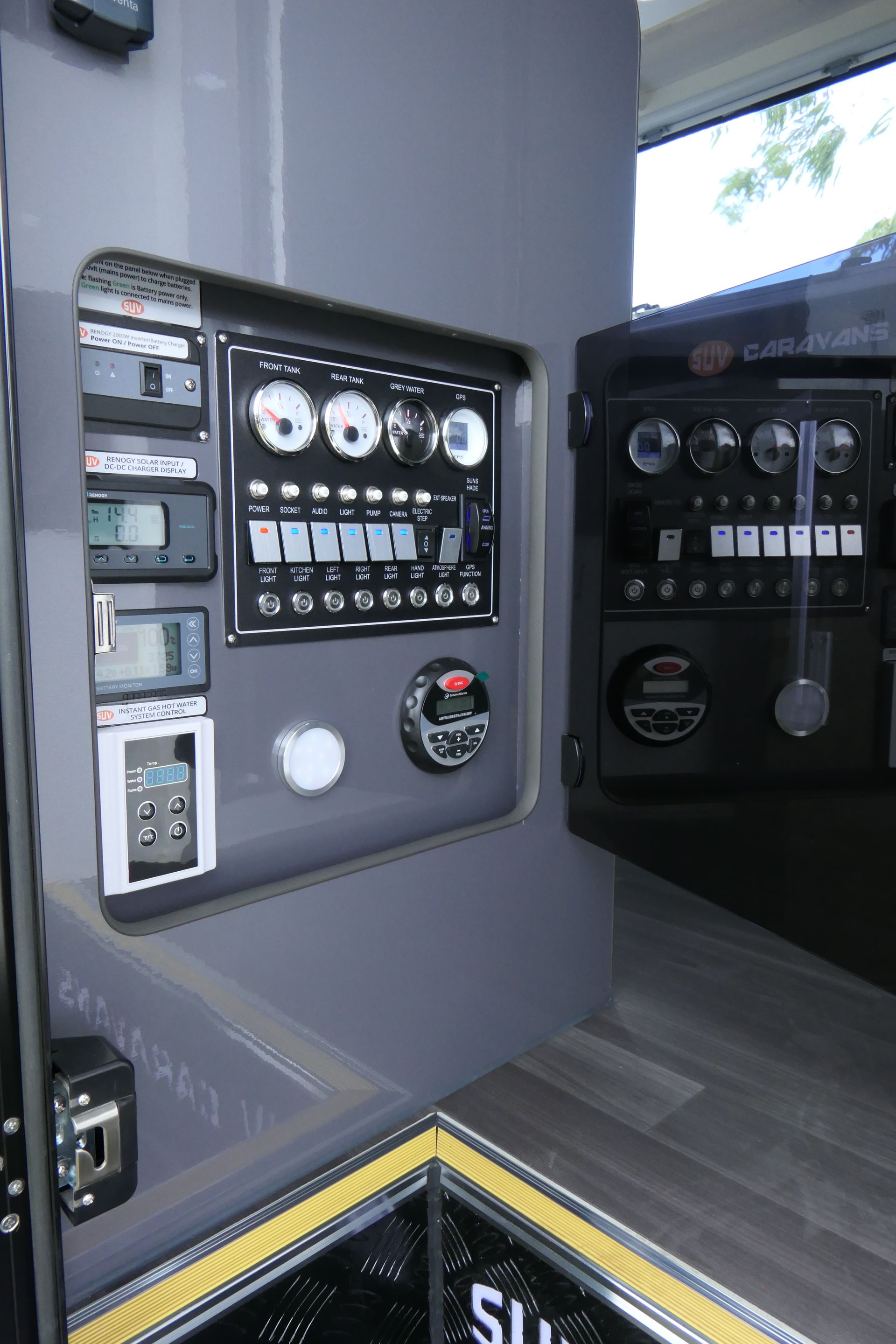 The inside of a bus with a lot of buttons on the wall.