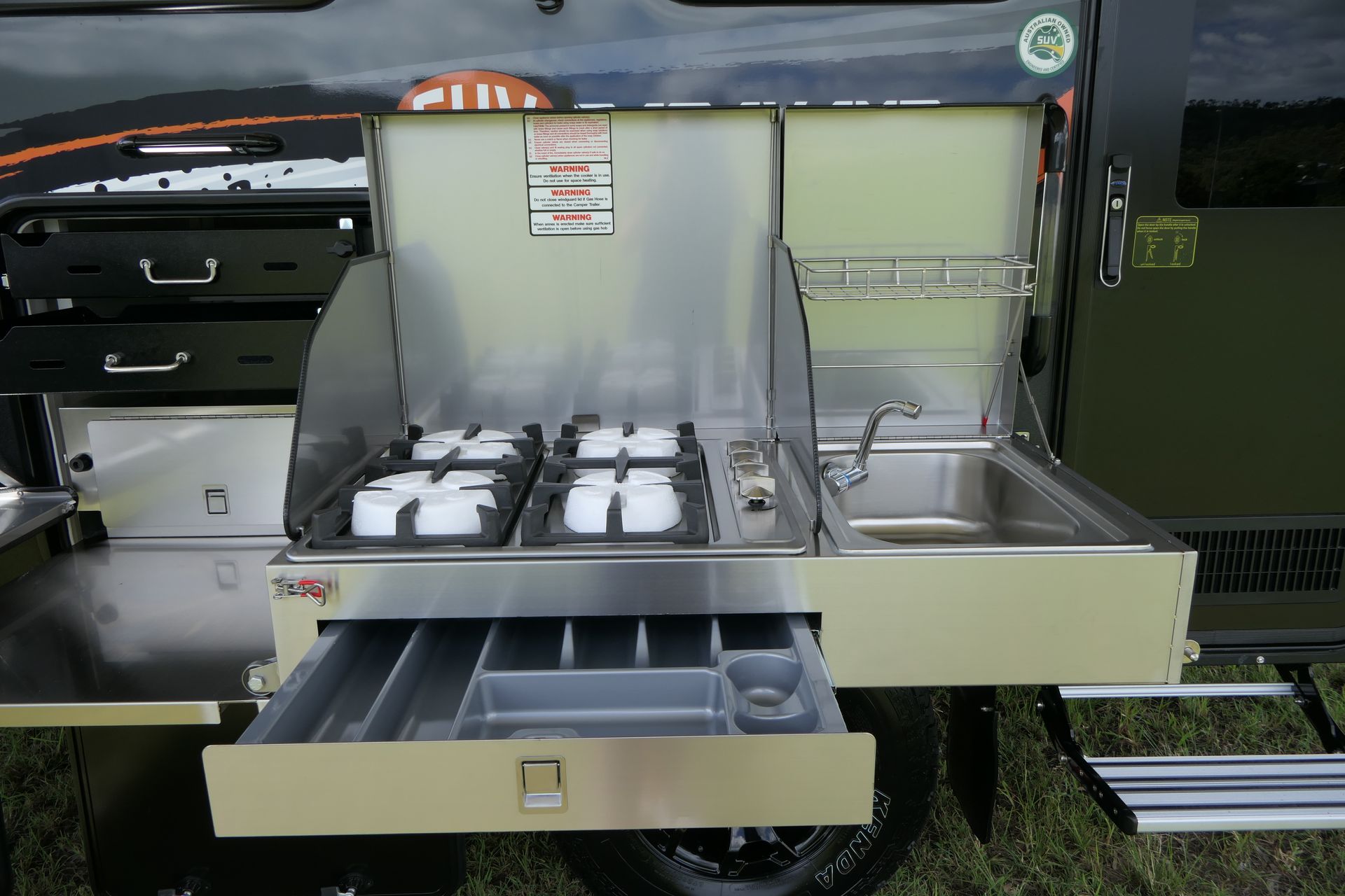 A camper with a stove and sink in it