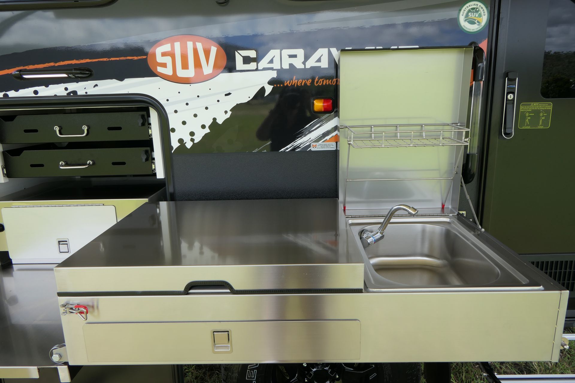A suv caravan with a stainless steel counter top and sink
