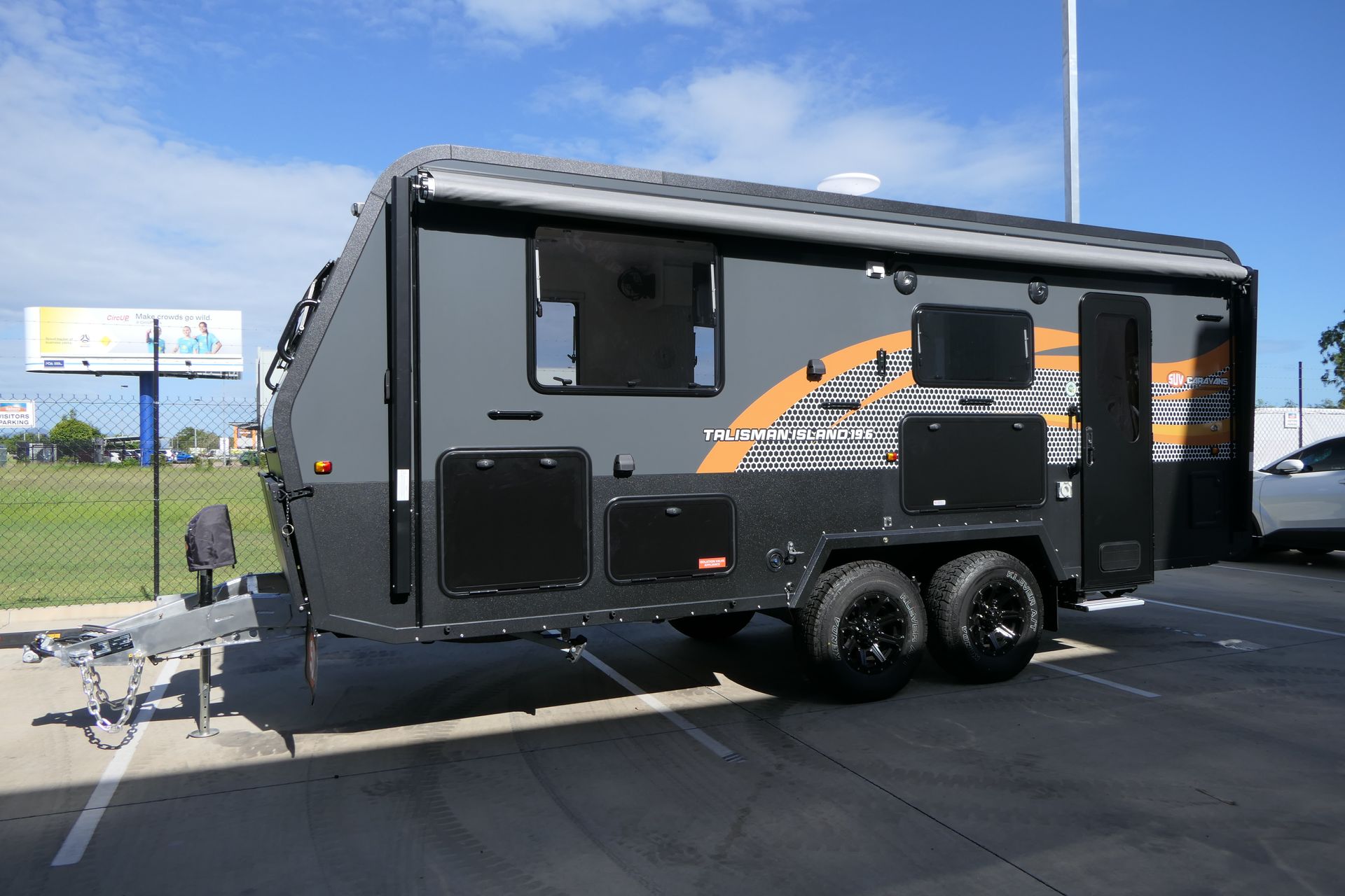 A camper trailer is parked in a parking lot.