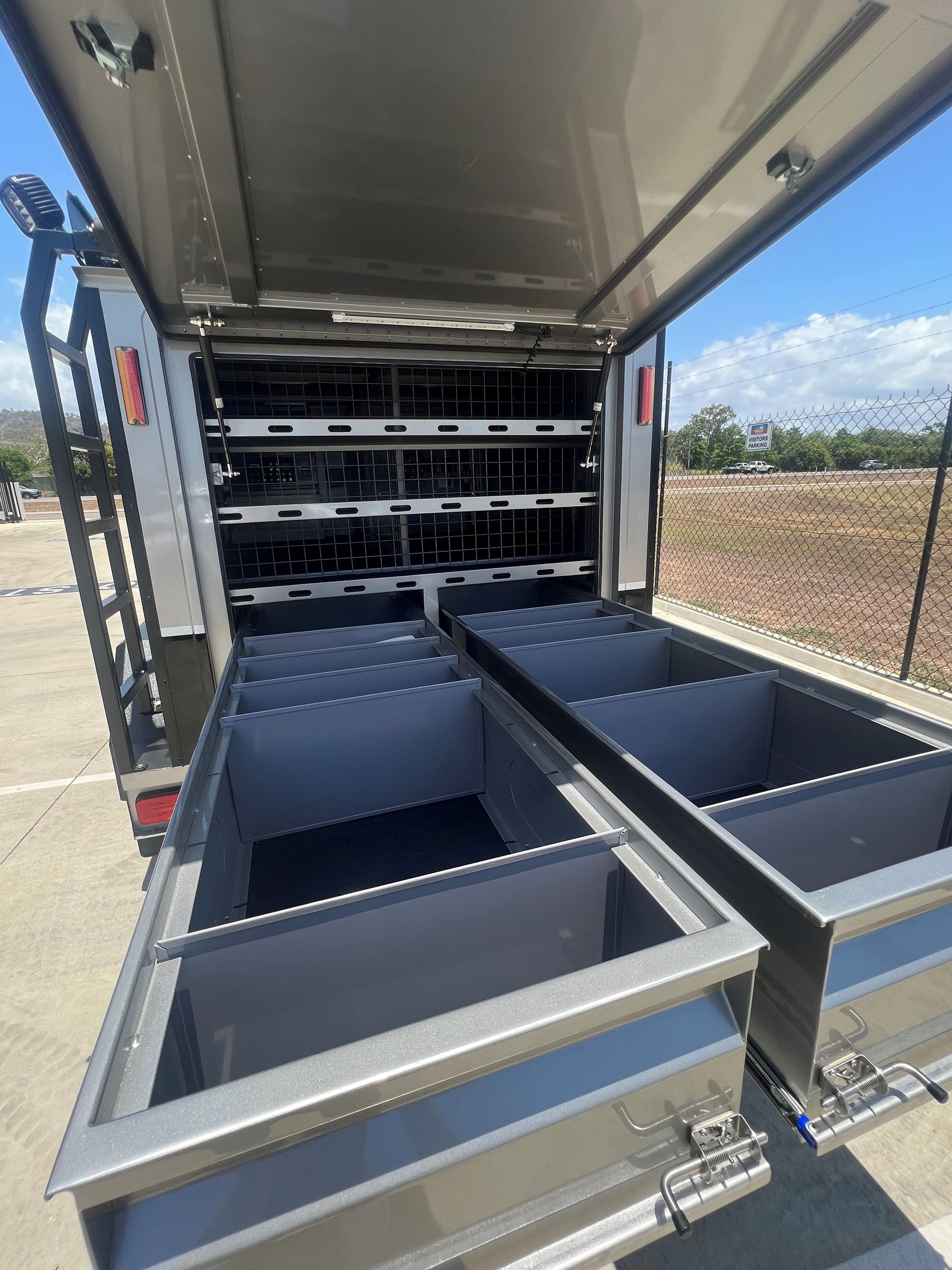 The inside of a truck with lots of drawers and shelves.