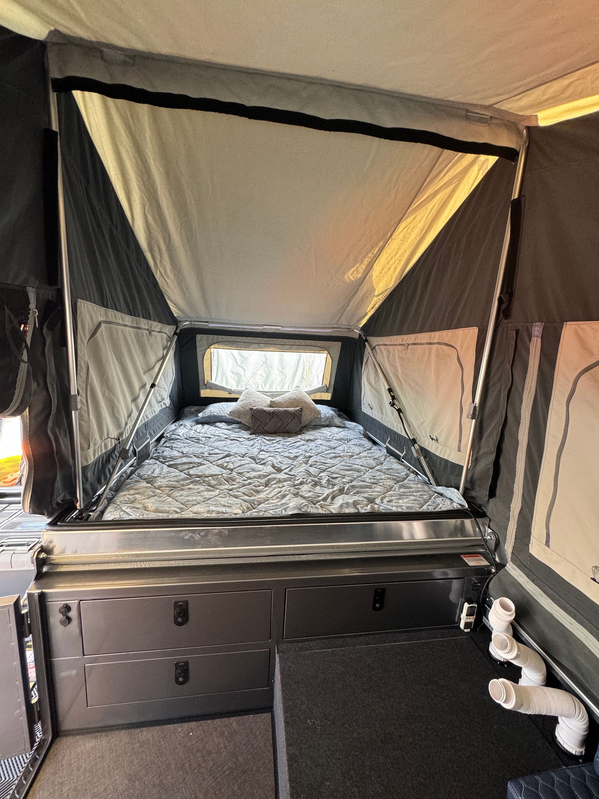 A tent with a bed in the middle of it
