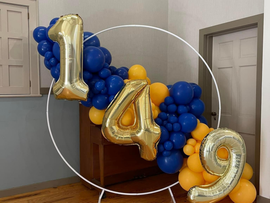 A bunch of blue and yellow balloons with numbers on them