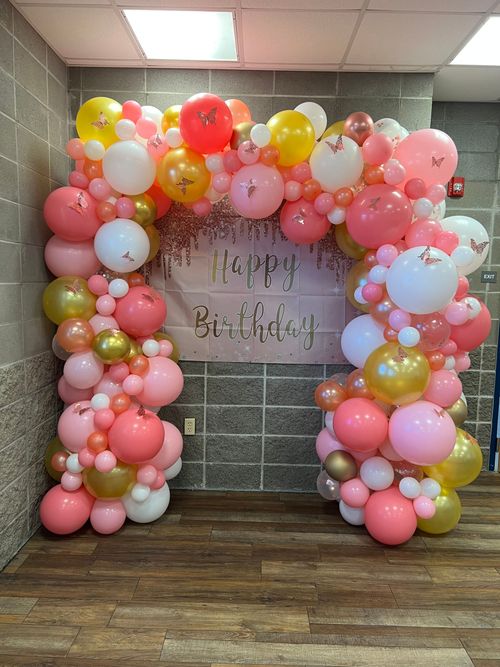 A room filled with balloons and a sign that says `` happy birthday ''.