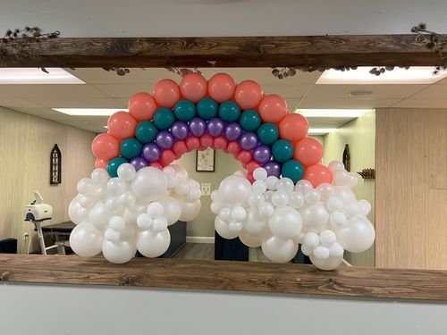 A room filled with balloons and a sign that says `` happy birthday ''.