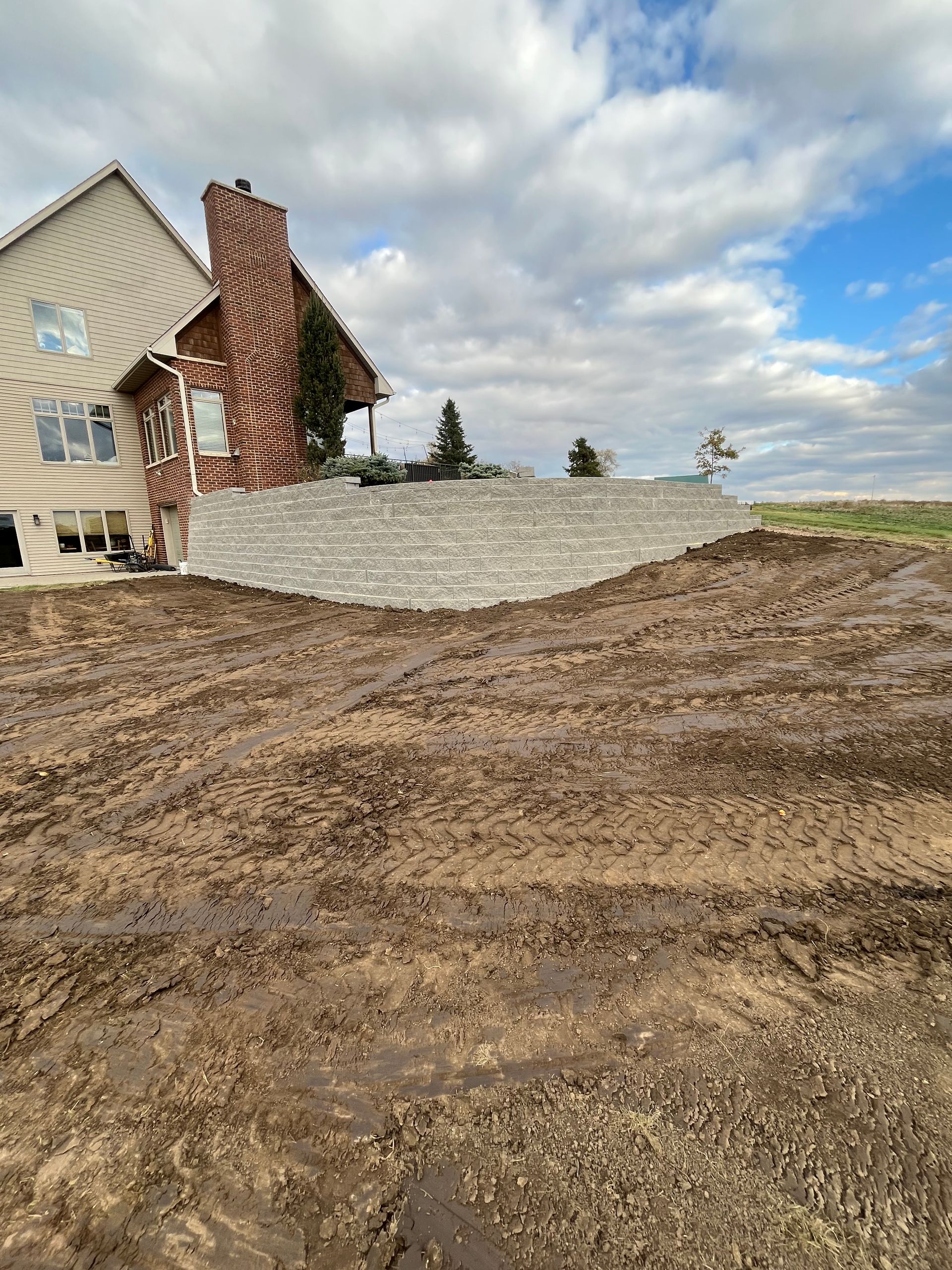 A patio is being built in the backyard of a house.