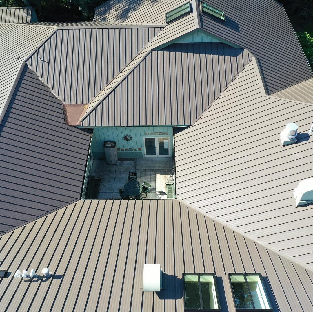 An aerial view of a house with a metal roof