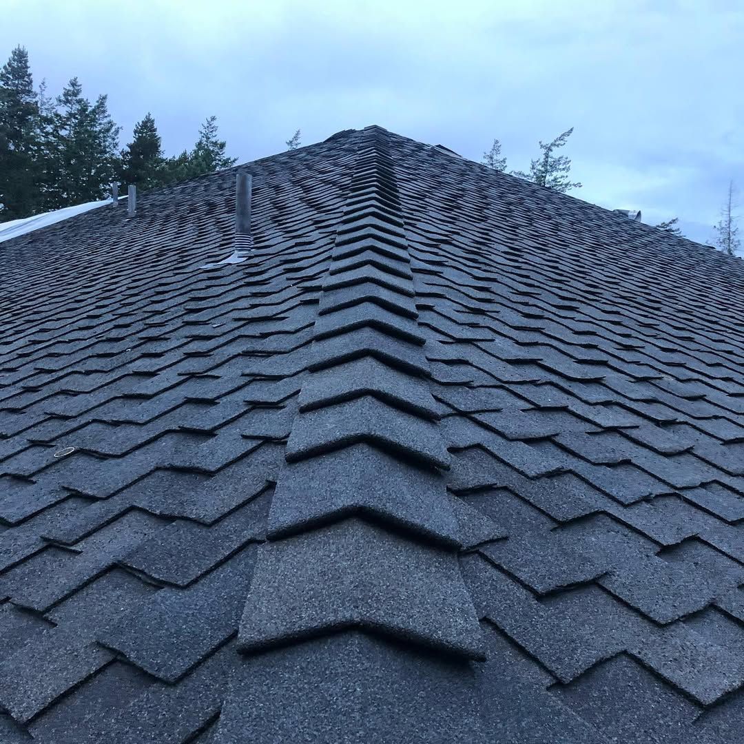 A close up of a roof with a lot of shingles on it.