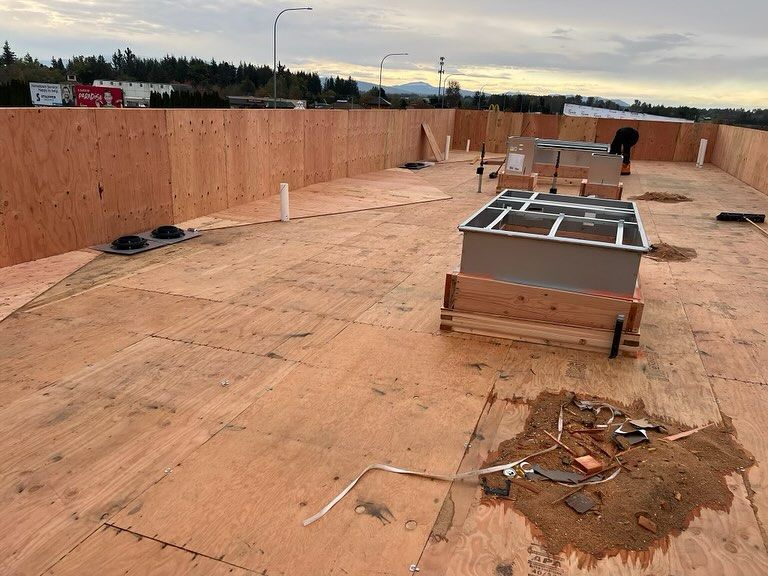 A roof is being built with a lot of plywood.