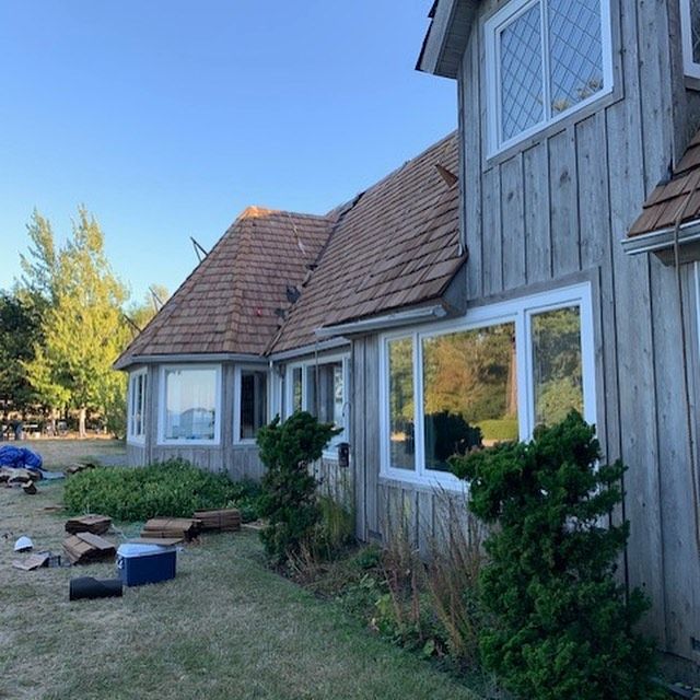 A house with a lot of windows and a roof
