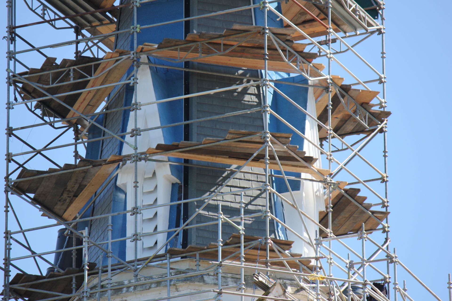 A tower is being built with scaffolding around it