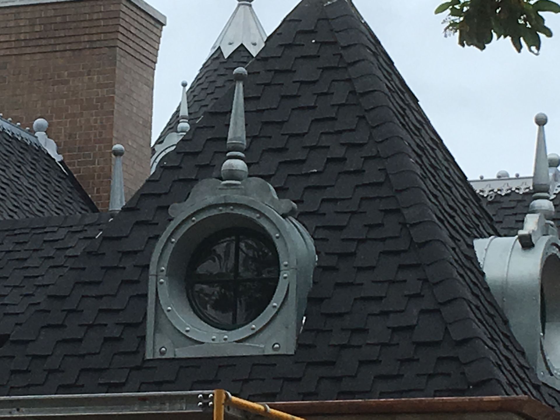 The roof of a building has a round window on it