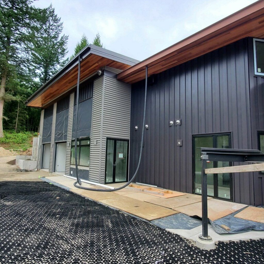 A large black building with a hose attached to it