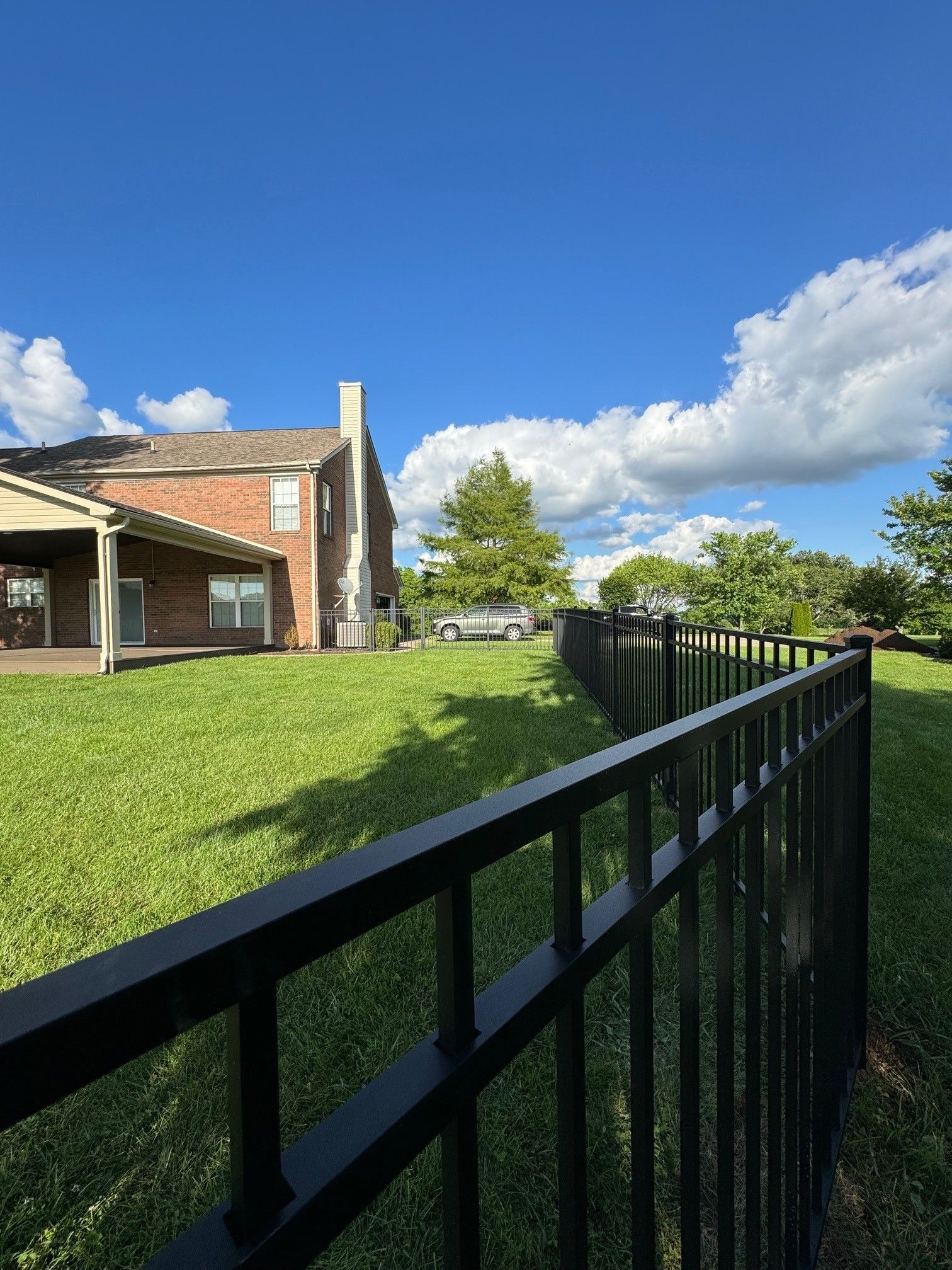 A house with a black fence in front of it