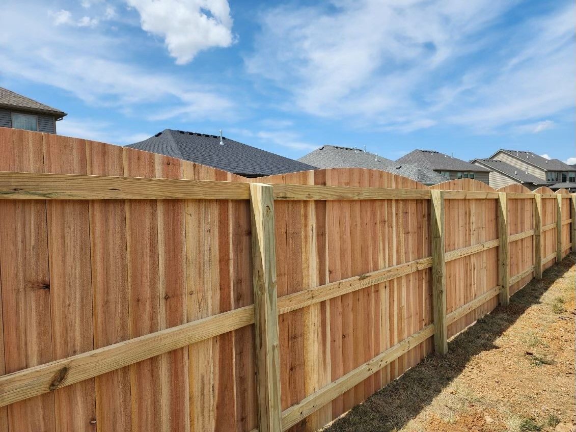 A wooden fence is surrounded by houses in a residential area — Lexington, KY — Chafin Fence LLC