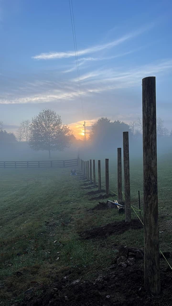 A Fence in a Foggy Field with a Sunset in the Background — Lexington, KY — Chafin Fence LLC