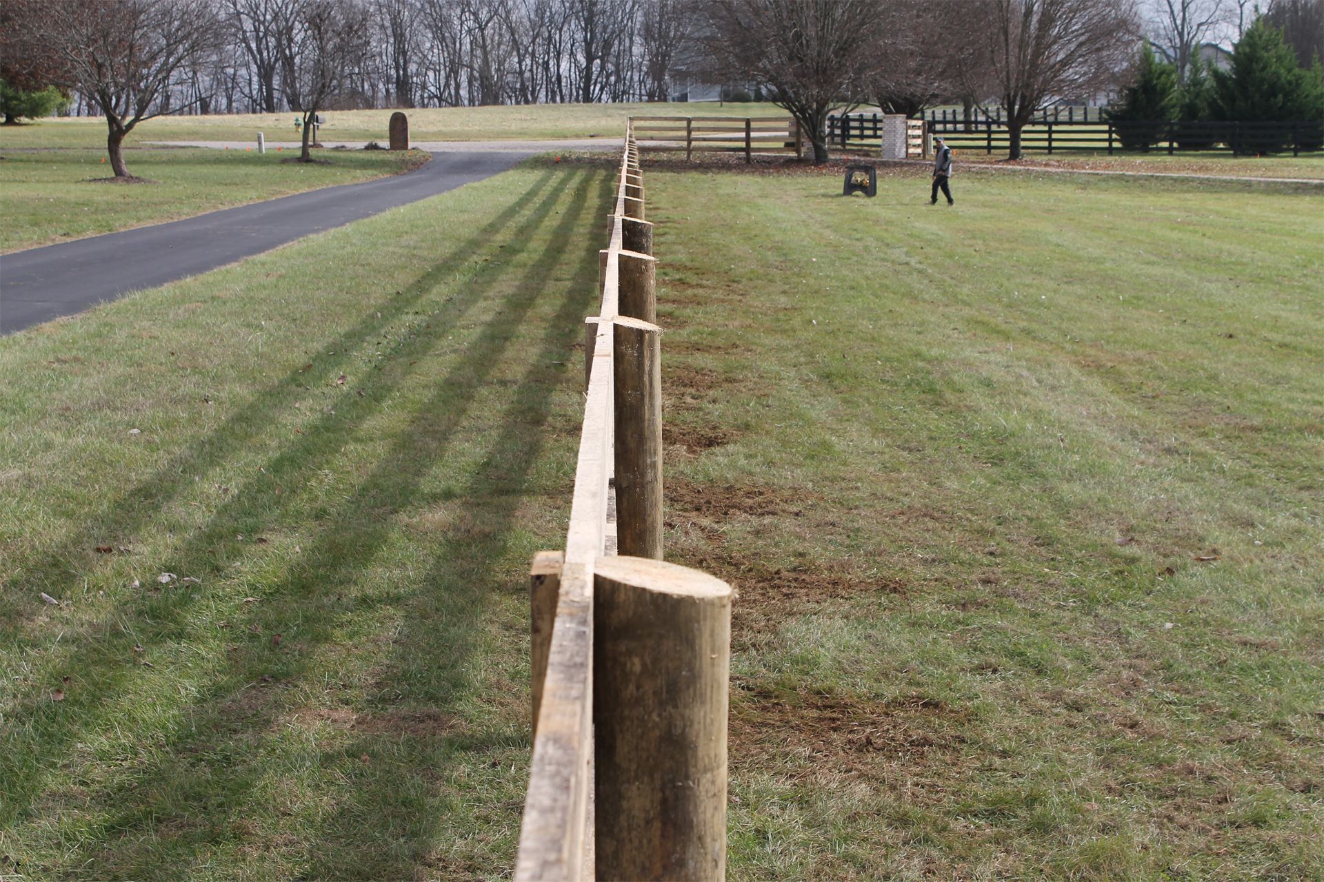 Wooden Fence is in the Middle of a Grassy Field — Lexington, KY — Chafin Fence LLC