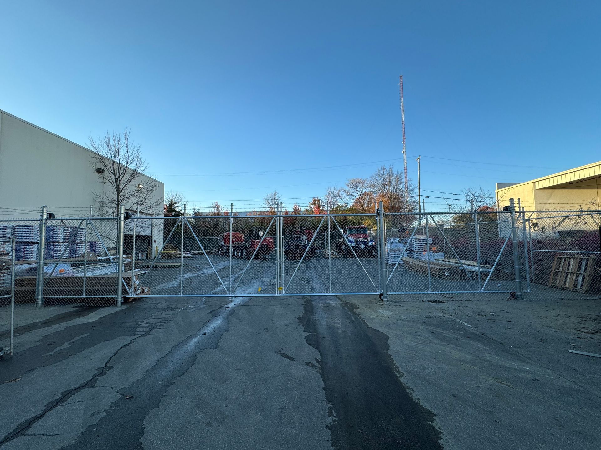 a large metal gate is sitting in the middle of a parking lot — Lexington, KY — Chafin Fence LLC