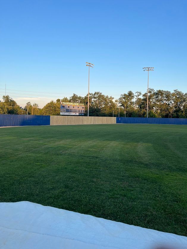 a baseball field with a blue fence and a blue sky in the background — Lexington, KY — Chafin Fence LLC