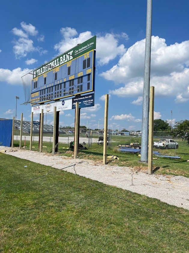 a large scoreboard is sitting on top of a lush green field — Lexington, KY — Chafin Fence LLC