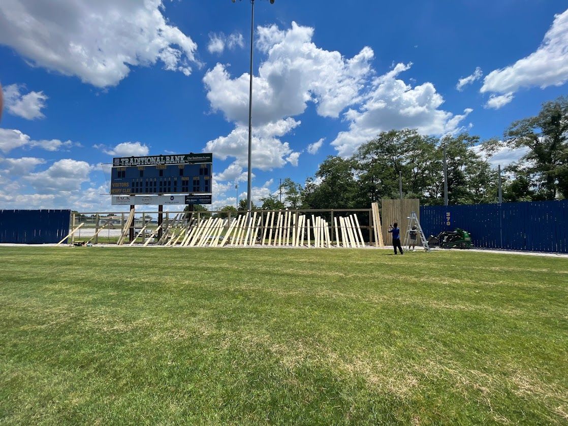 a football field with a scoreboard in the background on a sunny day — Lexington, KY — Chafin Fence LLC